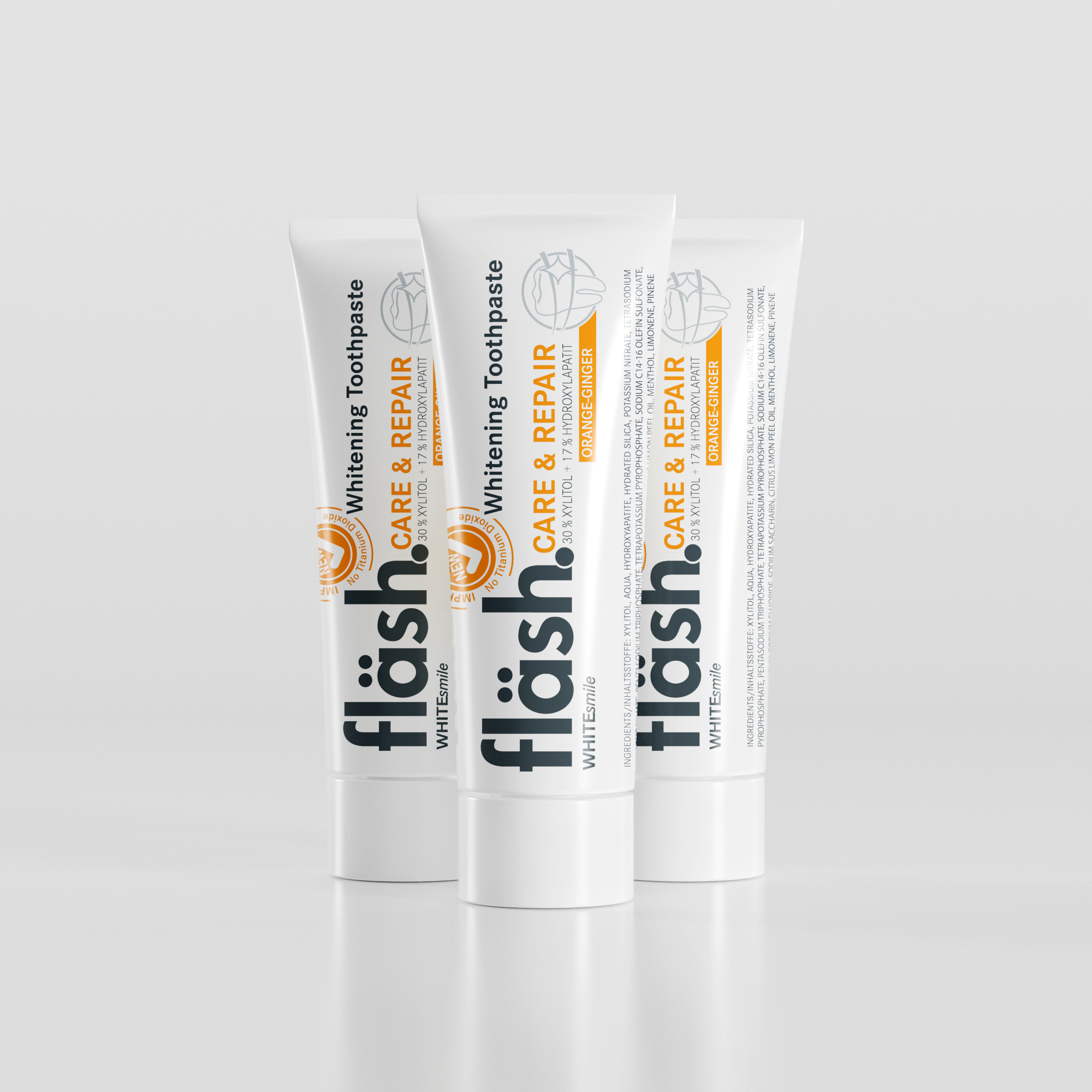 Drei Tuben fläsh Zahnpasta auf hellgrauem Hintergrund. Auf den Tuben steht neben dem schwarzen Fläsh Logo in Orange die Beschreibung: "fläsh care and Repair Whitening Toothpaste" und die Sorte "Orange-Ingwer".